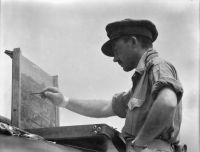 Lieutenant Charles Bush, official war artist, paints the scene where the Japanese paratroopers landed in 1942; photographed by Sgt K.B. Davis, Oesaoe Ridge, Dutch Timor, 1945; from the collection at the Australian War Memorial 120251