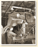 Workers assembling military truck at the plant of Ford Motor Company of Canada, Windsor, Ont., November 1940. Photo Credit: NFB NEG WRM-359, CWM Reference Photo Collection