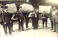 Turks carrying heavy bales of rugs, ca 
1930s.