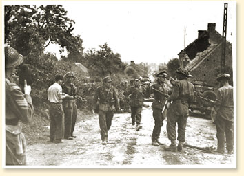 German troops surrendering to the South Alberta Regiment at St-Lambert-sur-Dives in the 'Falaise Pocket', August 1944.  Major D.V. Currie, on the left with a pistol in hand, won the Victoria Cross, the highest combat decoration in the British Commonwealth, for his leadership in these operations. Canadian Military Photograph, No 38879, CWM Reference Photo Collection