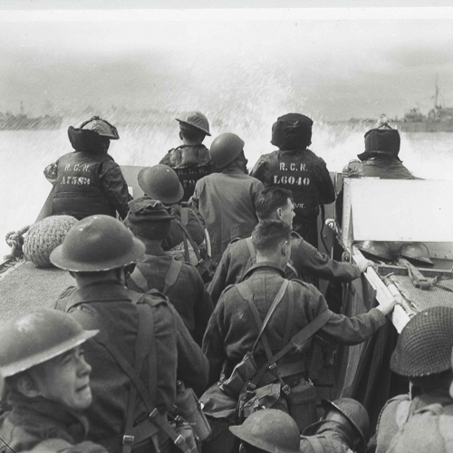 Canadian soldiers wearing Mark II helmets on a landing craft.