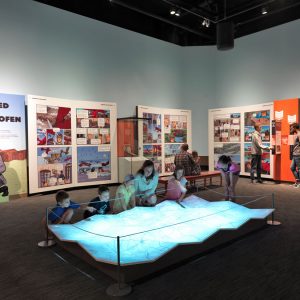 Children and adults engaging with an exhibition interactive