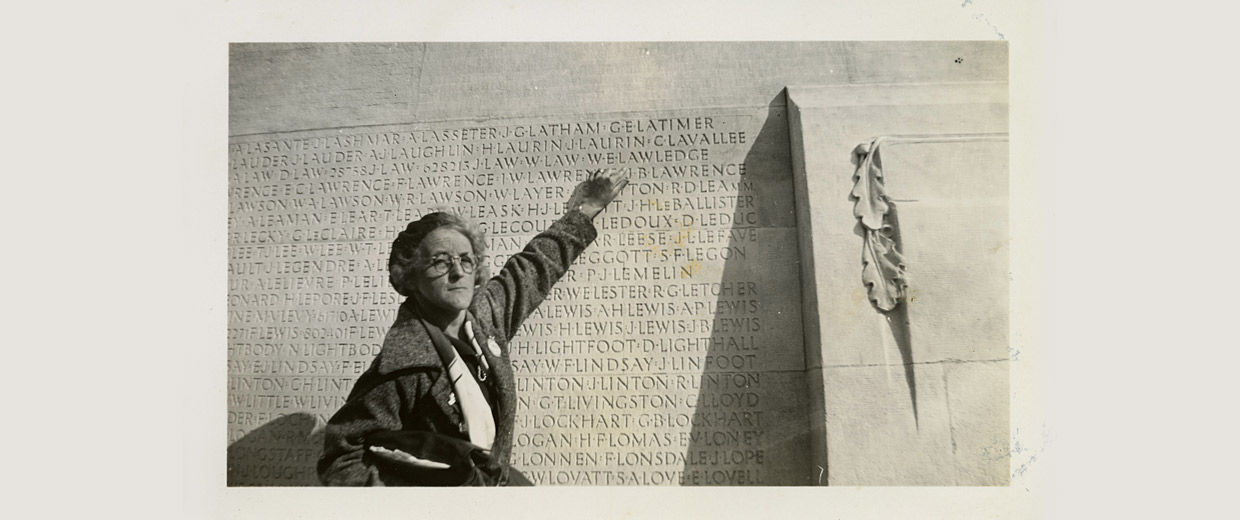 An old photo of a man standing next to a wall at the Canadian War Museum in Ottawa.