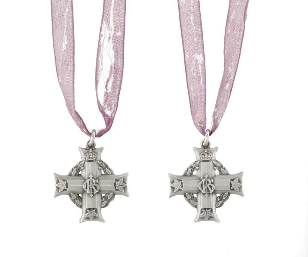 Two silver crosses on purple ribbons, each bearing the royal cypher of King George V, “GRI”, at the centre and maple leaves at the end of three arms.