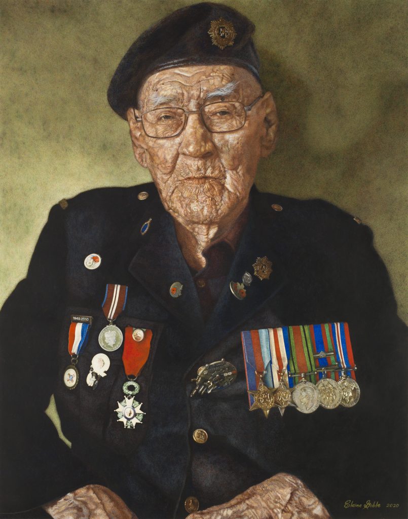 An elderly Philip Favel, wearing a uniform adorned with many badges and medals, gazes directly at the viewer.