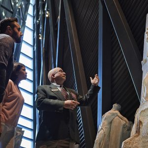 People are looking at a sculpture.