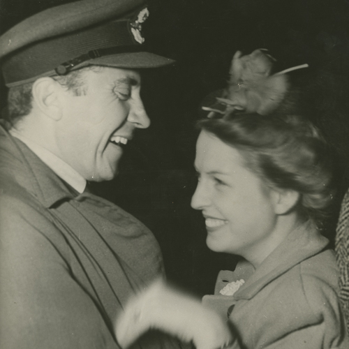 An old photo of a man and woman laughing at the Canadian War Museum in Ottawa.