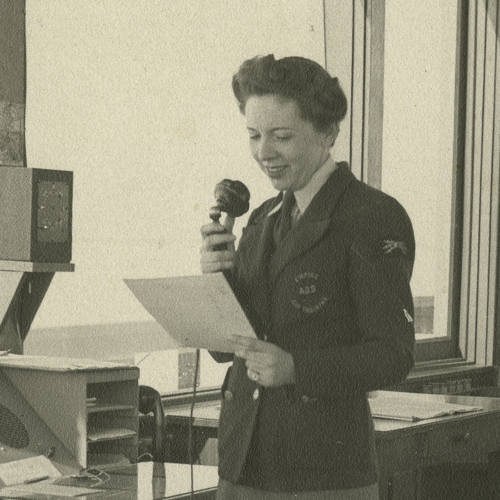 A woman in a uniform speaking into a microphone at the Canadian War Museum in Ottawa.