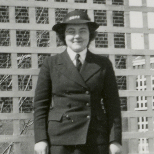 A woman in a uniform standing in front of a fence at the Canadian War Museum in Ottawa.