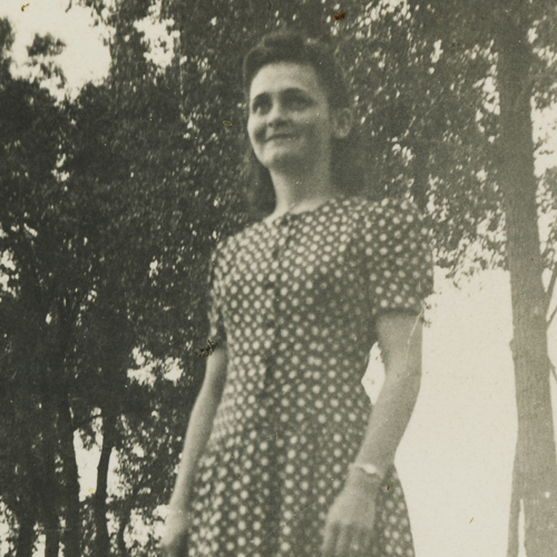 Description: A woman in a polka dot dress standing in Ottawa, near the Canadian War Museum.