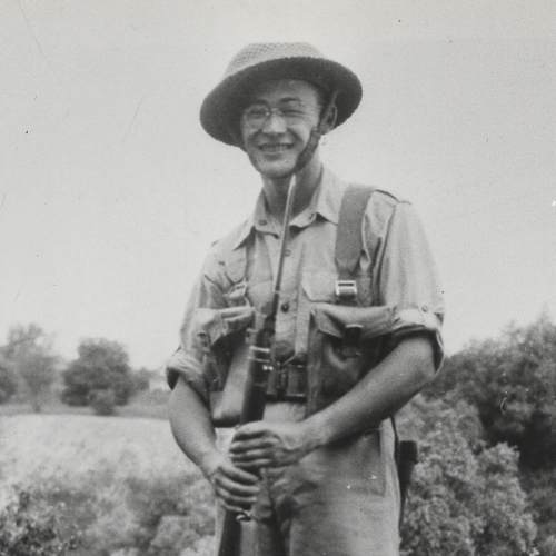 A man in uniform with a rifle and hat standing in the Canadian War Museum in Ottawa.