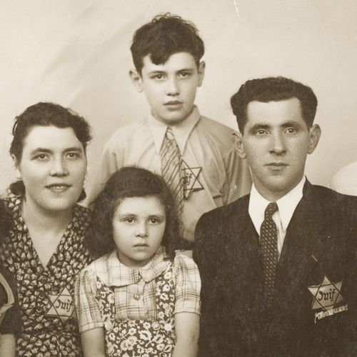 A family posing for a picture in front of the Canadian War Museum.