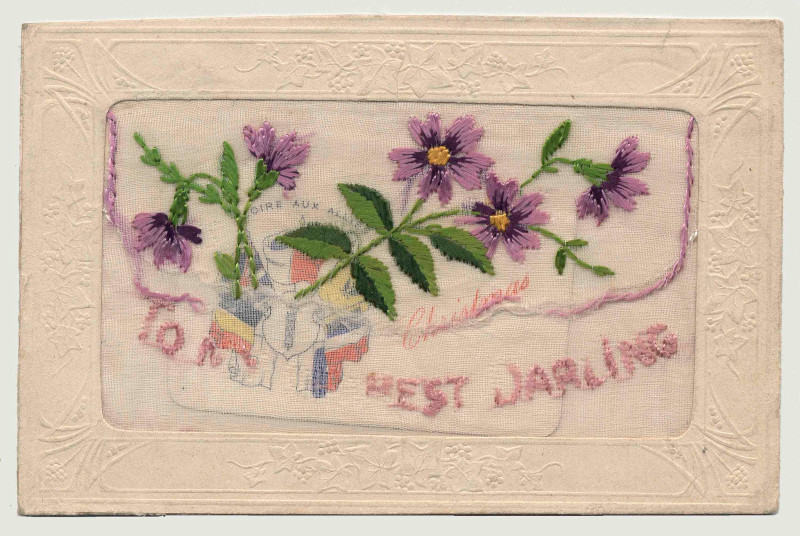 A rectangular piece of embroidery showing purple flowers with green leaves and purple text reading “To My Best Darling.”