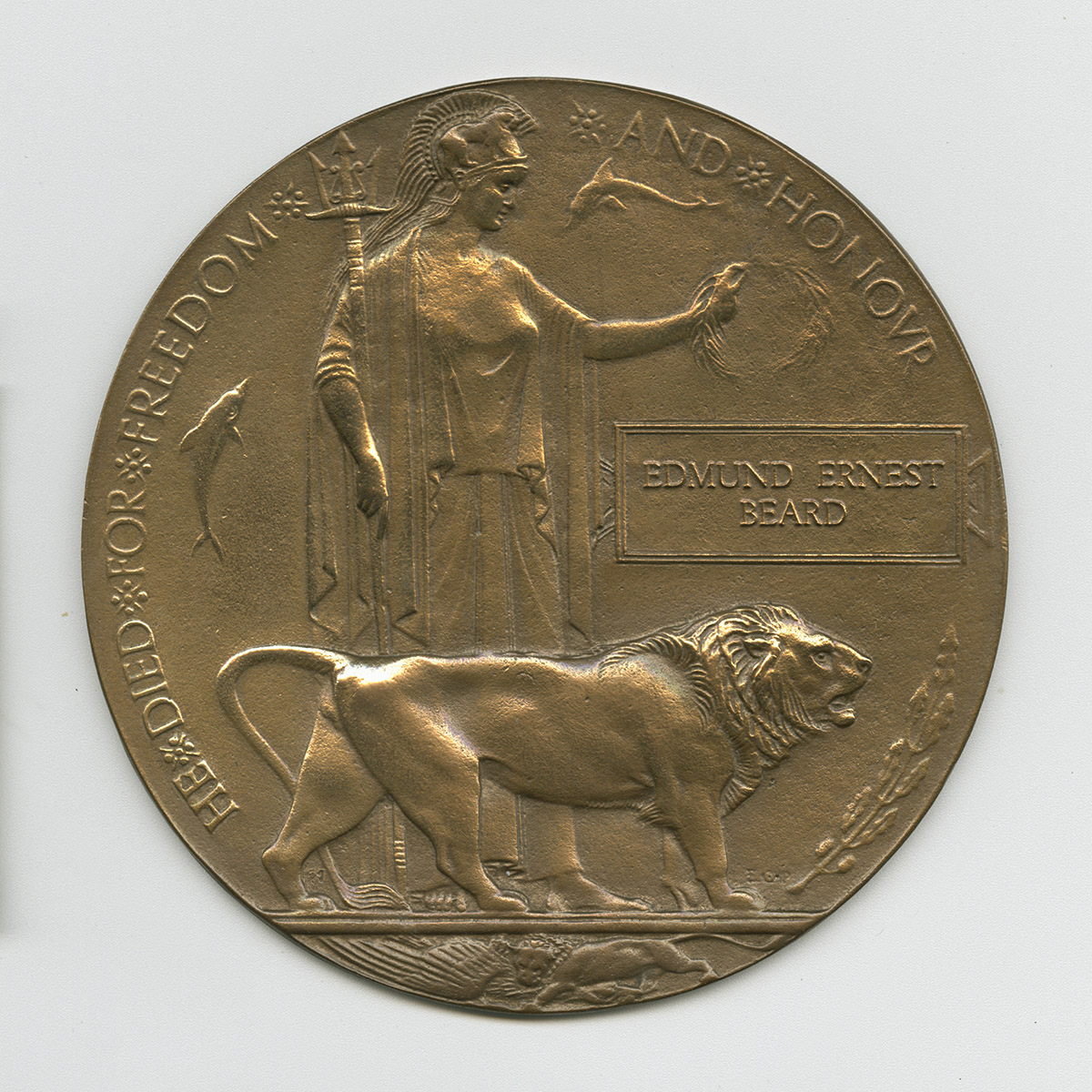 Bronze medallion with Roman soldier and lion. The medallion is inscribed with the soldier’s name and reads: “He Died for Freedom and Honour.”