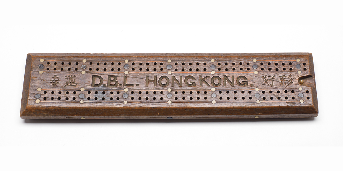 Wooden game board with inscription “D.B.L. Hong Kong” and Japanese writing.