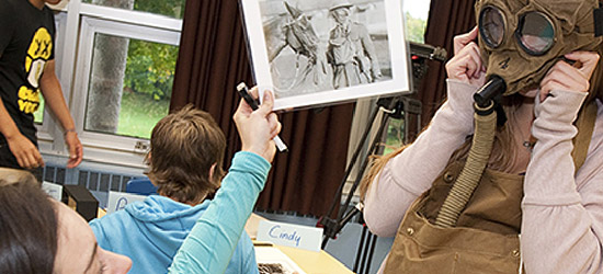 Students with reproduction artifacts related to Canadian military history
