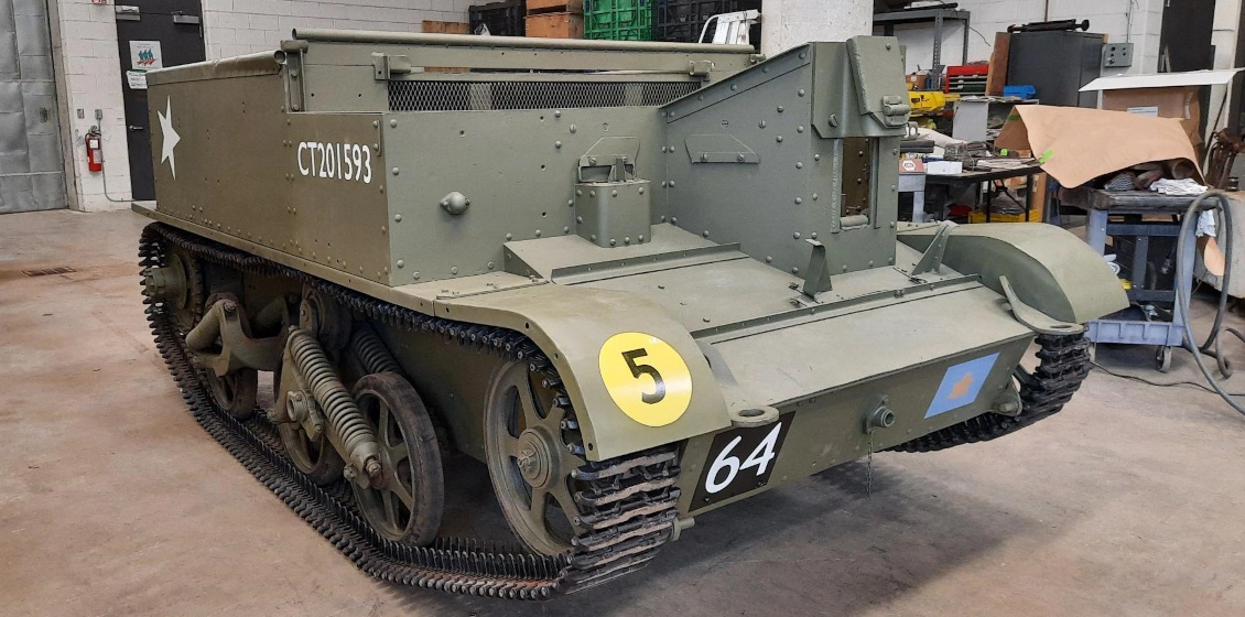 A low, boxy, green armoured vehicle with tracks.