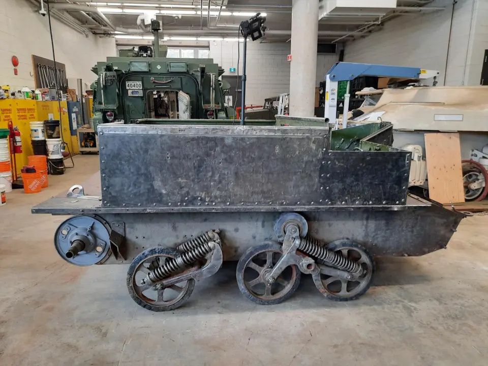 The same vehicle, now with a completely black exterior and with almost no visible rust.