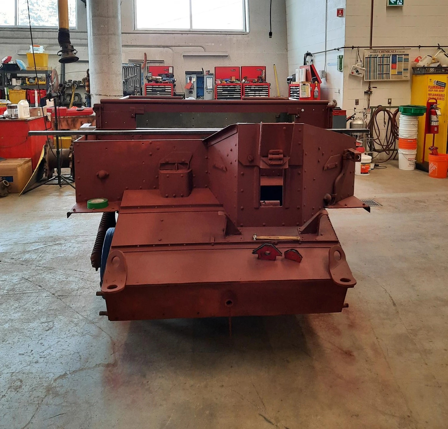 A front view of the vehicle, which is now a dark brownish red all over.