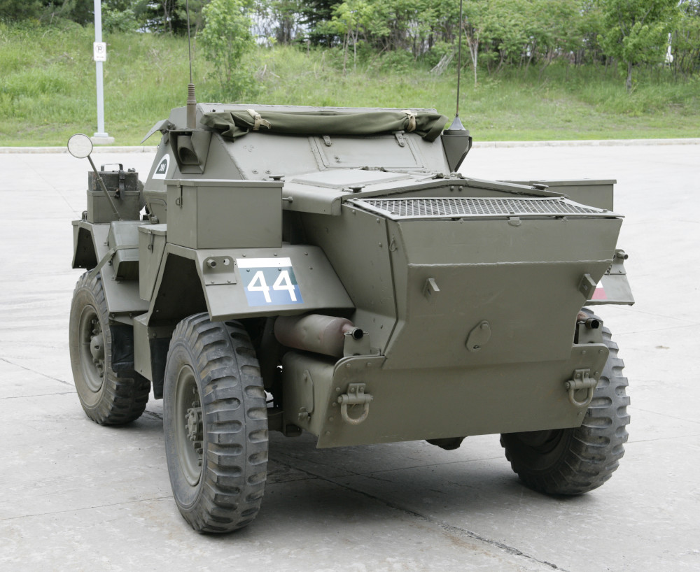 A small, green armoured vehicle with wheels and numerous radio antennas.