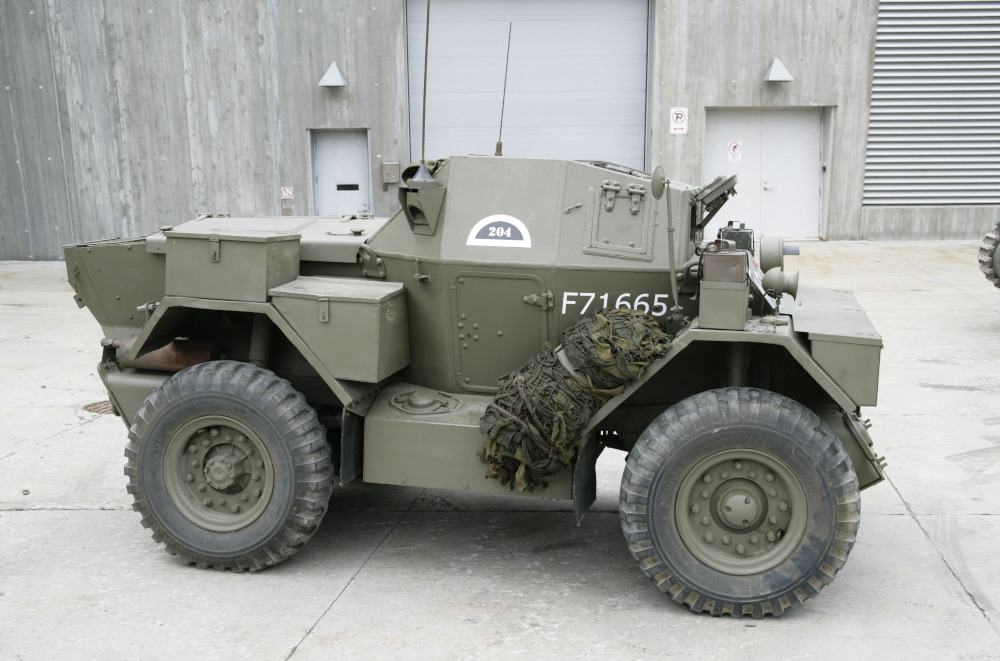 A small, green armoured vehicle with wheels and numerous radio antennas.