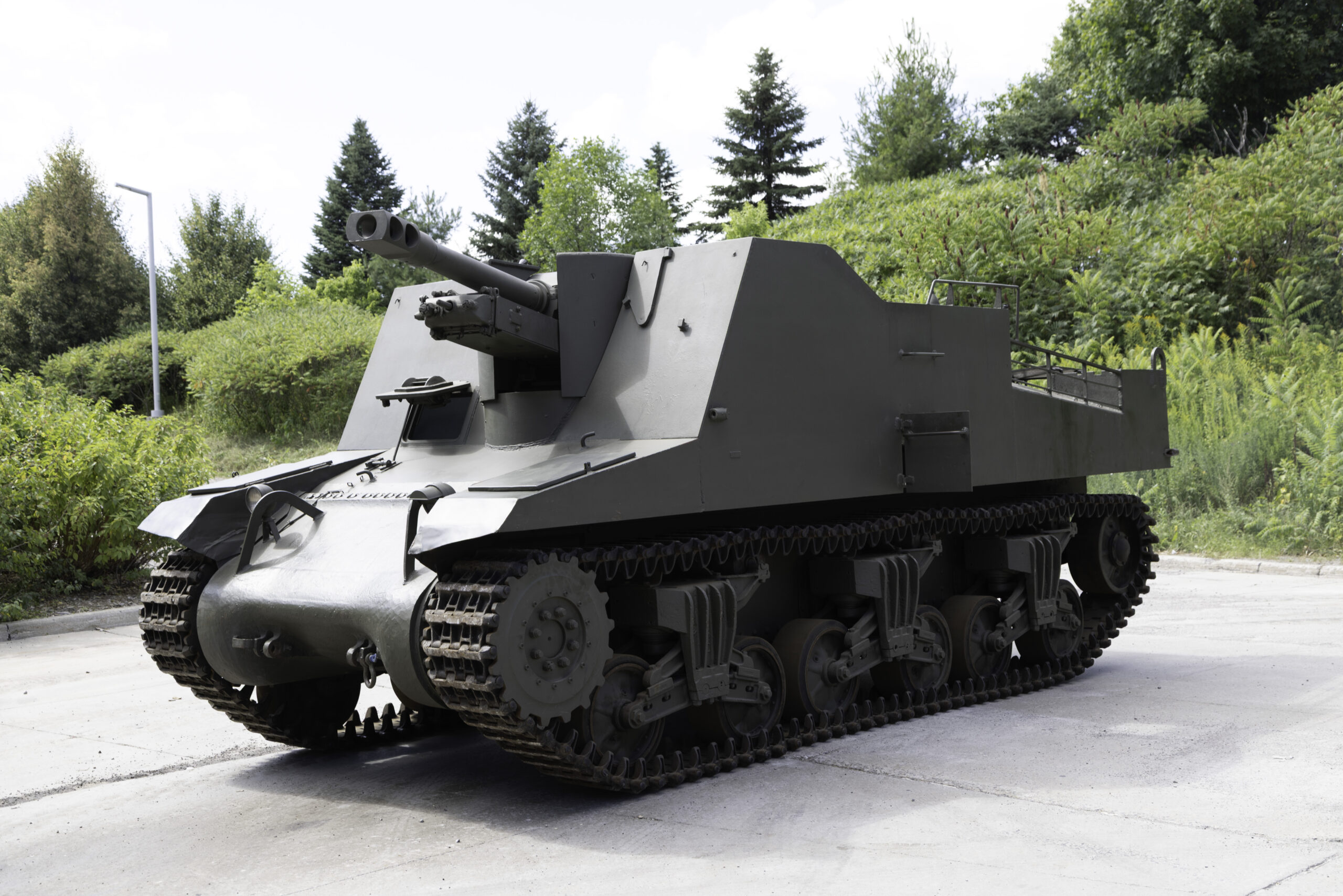 A green military tank with high, square armoured sides and a large forward-facing main gun.